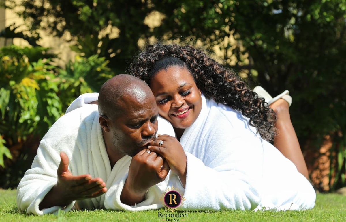 Couple relaxing on the lawn in spa robes