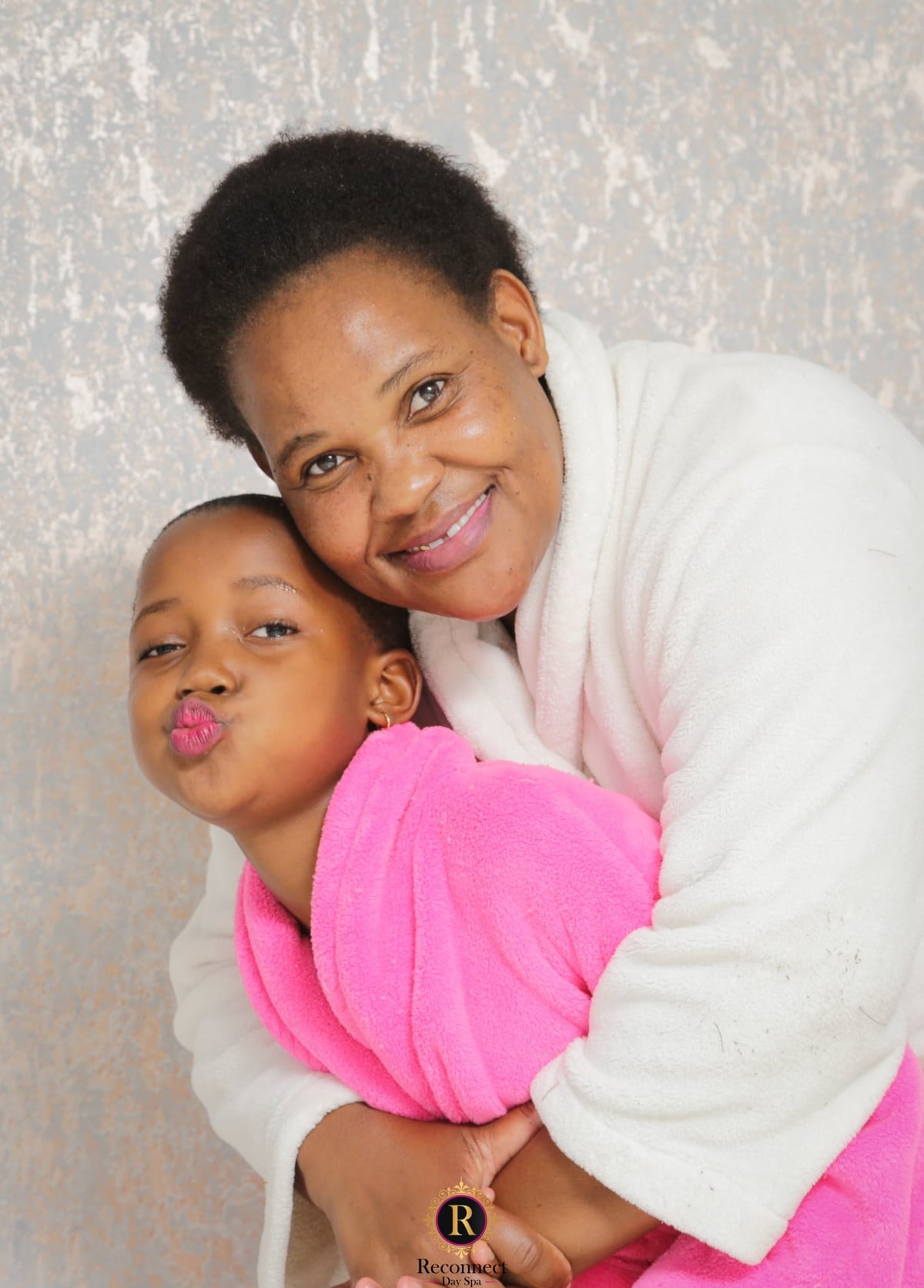 Mom and daughter hugging during a mom and daughter spa day
