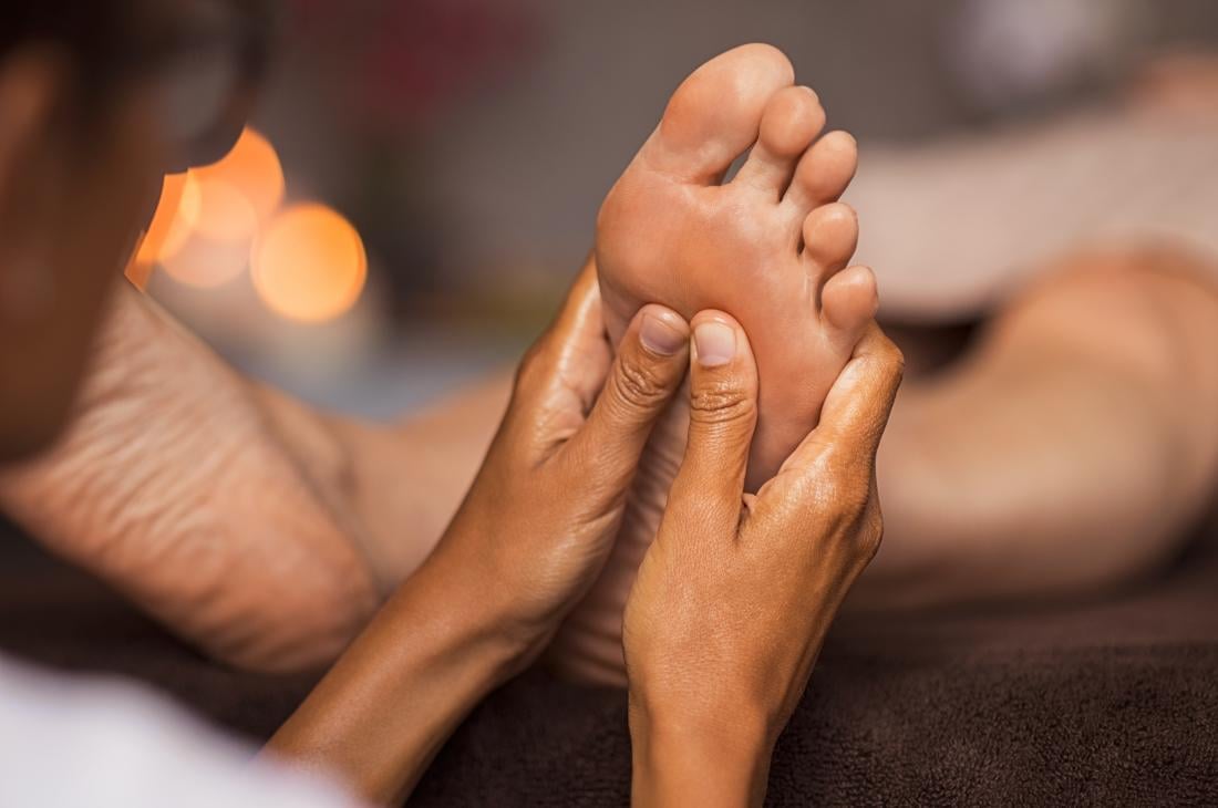 Therapist massaging the sole of a client's foot – Foot Massage, Reconnect Day Spa
