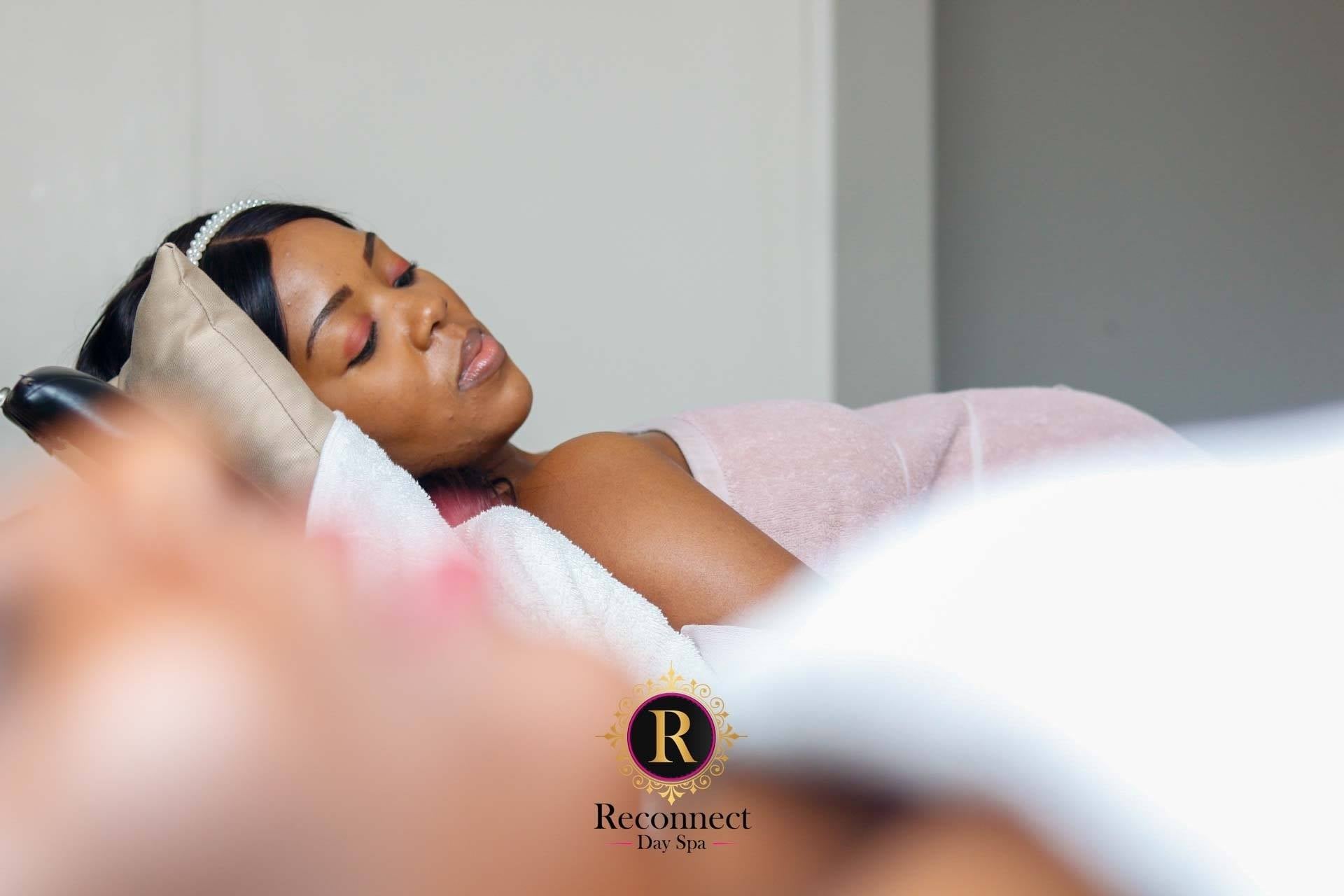 Woman resting comfortably on a pillow during a massage – Self-care Sundays Spa Special, Reconnect Day Spa