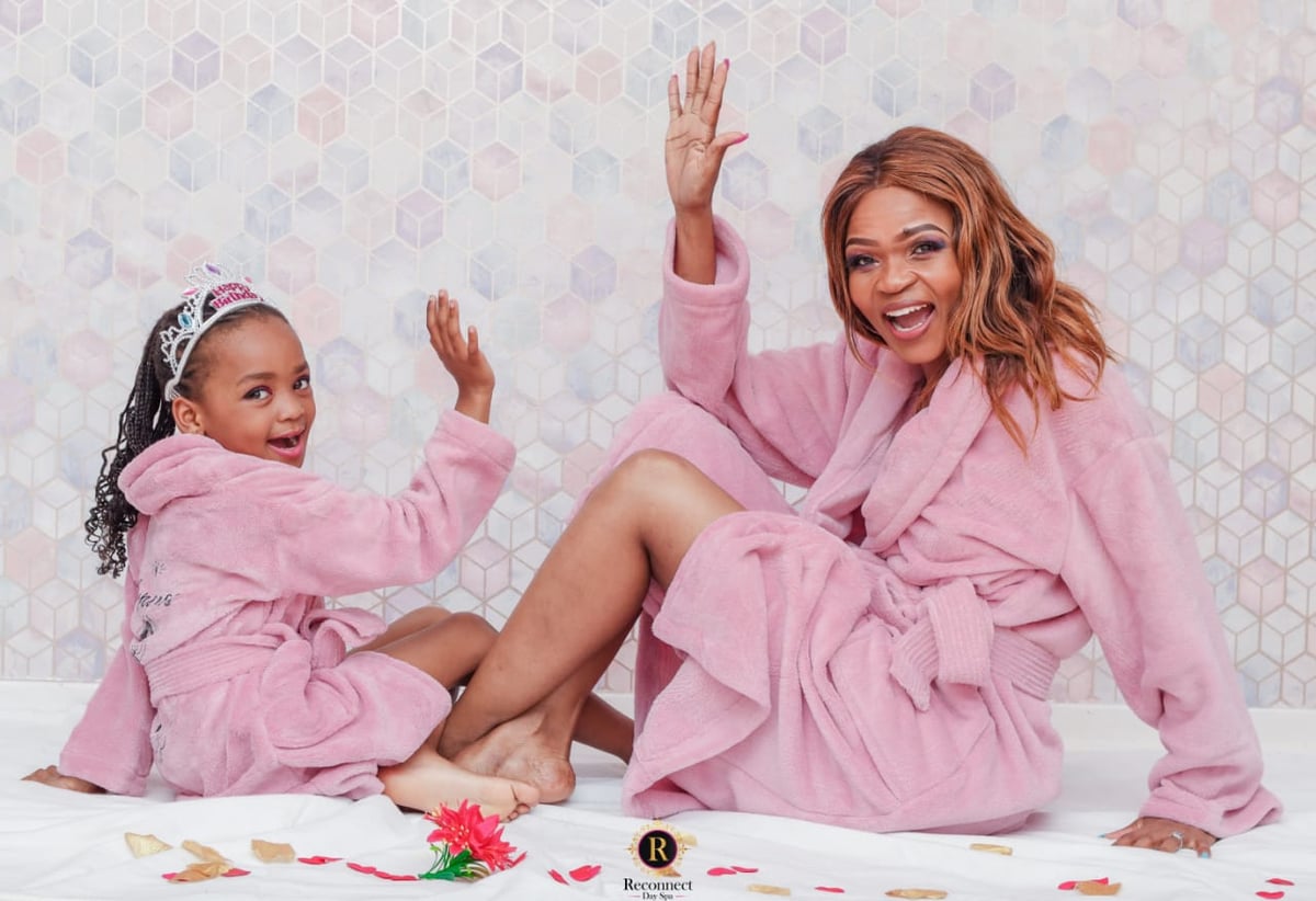 Mom and daughter in pink spa robes giving a high five – Mom & Daughter Spa Special, Reconnect Day Spa