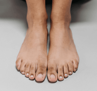 Freshly painted toenails in pink, coral, blue and nude – Express Pedicure, Reconnect Day Spa