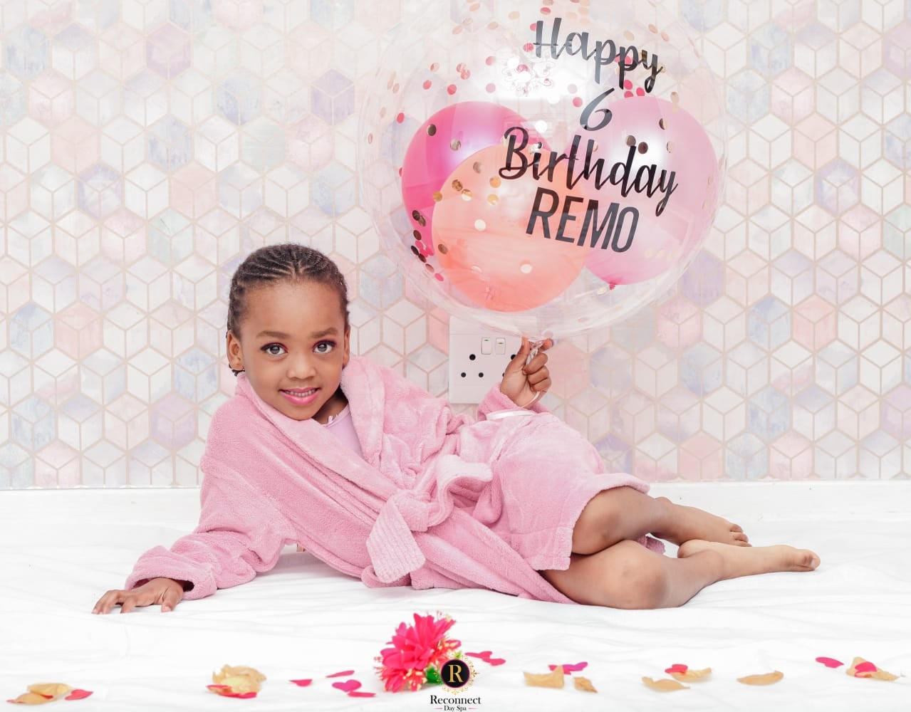 Little girl in a pink spa robe holding a birthday balloon – Kids Big Spoil Spa Day for 1, Reconnect Day Spa